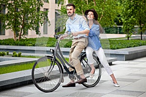 Young couple sitting on a bicycle