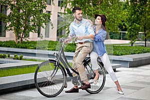 Young couple sitting on a bicycle