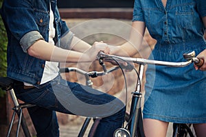 Young couple sitting on a bicycle opposite the