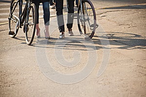 Young couple sitting on a bicycle opposite the