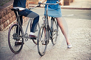 Young couple sitting on a bicycle opposite the