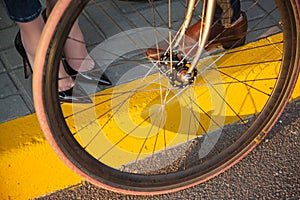 Young couple sitting on a bicycle opposite the