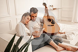 young couple sitting on couch with