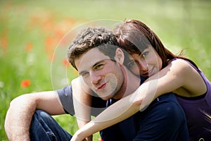 Young couple sitting in a field