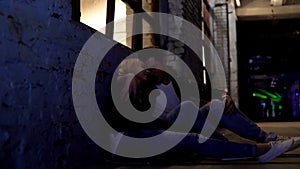 Young couple sitting on floor, talking about problems and hugging, support