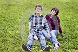 Young couple sitting on grass