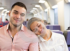 Young couple sitting in modern train