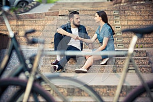 Young couple sitting opposite a bicycle