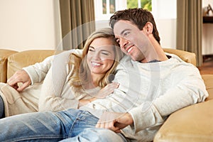 Young couple sitting and relaxing on sofa