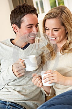 Young couple sitting and relaxing on sofa