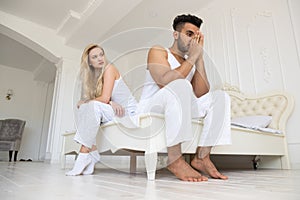 Young Couple Sitting Separate On Bed, Having Conflict Relationships Problem, Sad Negative Emotions Hispanic Man And