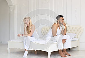 Young Couple Sitting Separate On Bed, Having Conflict Relationships Problem, Sad Negative Emotions Hispanic Man And