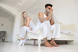 Young Couple Sitting Separate On Bed, Having Conflict Relationships Problem, Sad Negative Emotions Hispanic Man And