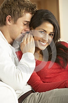 Young Couple Sitting On Sofa