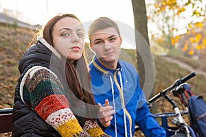 Young Couple Sitting Together on Park Bench