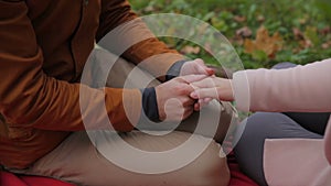 Young couple sitting together in a summer park and have a picnic on a checkered picnic blanket. couple in the park