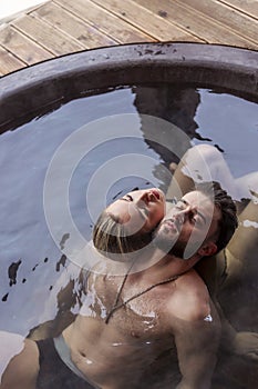 young couple sitting in a tub filled with water