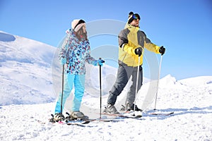 Young couple skiing on hill. Winter