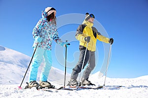 Young couple skiing on hill. Winter vacation