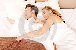 Young couple sleeping in bed