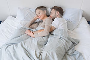 Young couple sleeping peacefully and hugging