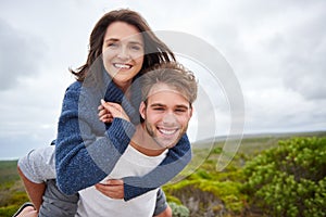 Young couple smiling confidently while outdoors together