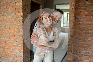 Young couple smiling and feeling happy after buying a flat in installments