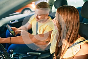 Young couple smiling happy driving car and using gps navigator smartphone