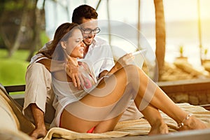 Young couple smiling and looking at tablet pc