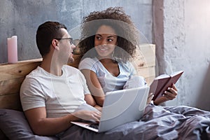 Young couple smiling to each other in bed