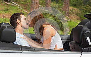Young couple smooching on the backseat