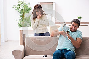 Young couple and snake in the flat