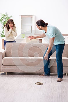 Young couple and snake in the flat