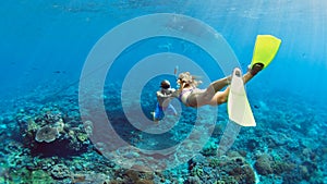 Young couple in snorkeling mask free dive underwater in sea