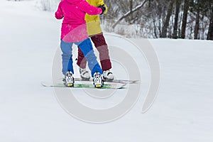 Young couple snowboarders slide down