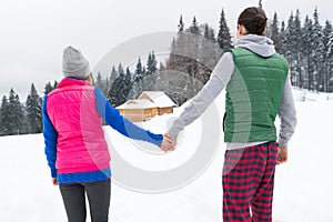 Young Couple Snowy Village Wooden Country House Man And Woman Winter Snow Resort Cottage