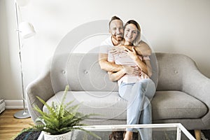 Young couple on the sofa relaxing at home