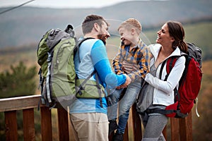 Young couple with son having fun on hiking