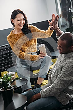 young couple spending time in cafe and giving