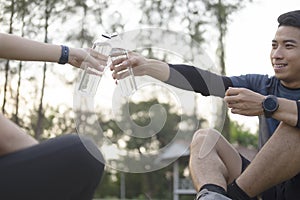 Young couple sporter drinking water after workout.