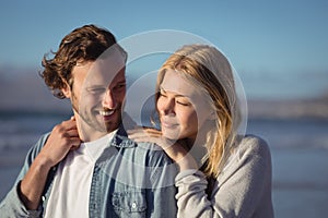 Young couple standing at beach