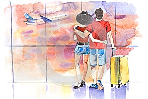 Young couple standing near window in airport before boarding