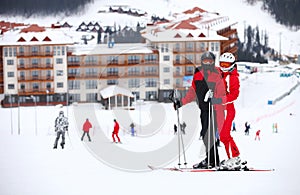 Young couple standing on a ski slope