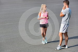 Young couple standing while talking after exercising