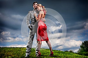 Young couple with storm cloudy sky