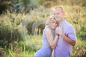 Young couple in the summer on the nature. The concept of relationships, love and relaxation