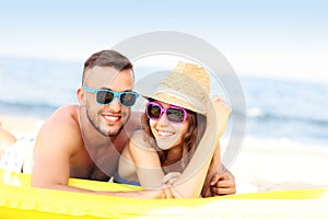 Young couple sunbathing on the beach