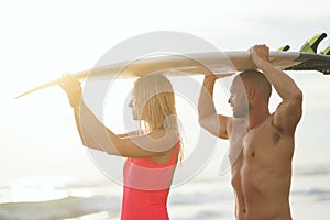 Young couple with surfboard outdoors