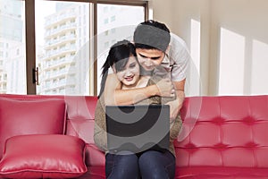 Young couple surfing internet at home