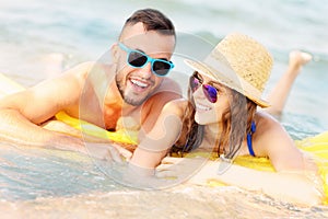 Young couple swimming on a matress